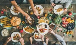 flatlay of friends feasting at thanksgiving day table with turkey picture id1063025552 copy 2
