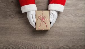 santa claus hands is holding a brown gift box picture id1177864040 copy 2